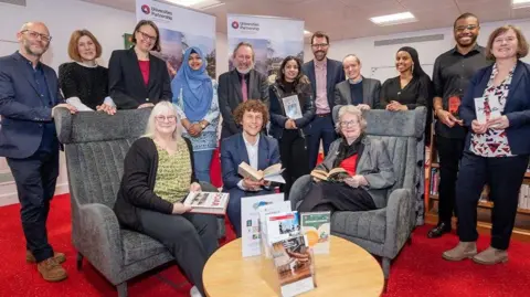 An image of Vi Dempster, Leicester’s assistant city mayor for leisure and culture, Paul Angrave from the Universities Partnership, and Christine Radford, Leicestershire County Council’s lead member for adults and communities, with partners who have worked on the project. 