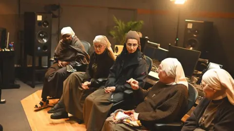 Dave Meyer 5 of the nuns pictured sitting down in a line in the Abbey Road recording studios