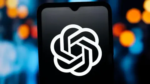 Getty Images The ChatGPT logo, in white, is visible against the backdrop of a dark phone screen.