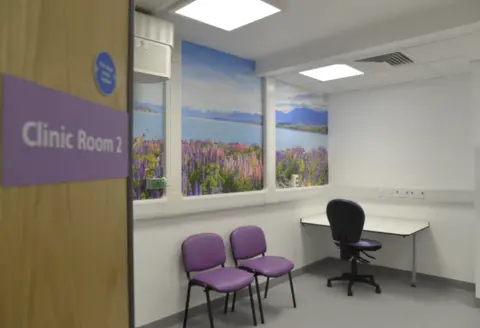 Nottingham University Hospitals (NUH) NHS Trust A clinic room with purple chairs and sign, which reads "Clinic Room 2*