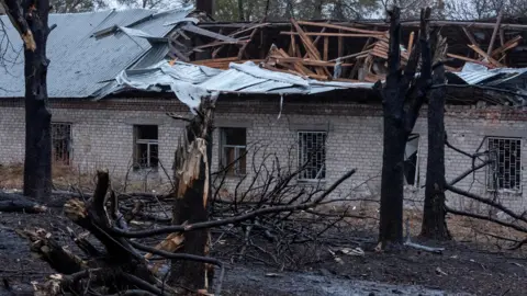 A destroyed house and trees mark the site of a Russian missile strike, amid Russia's attack on Ukraine, in Dnipro on 21 November. 