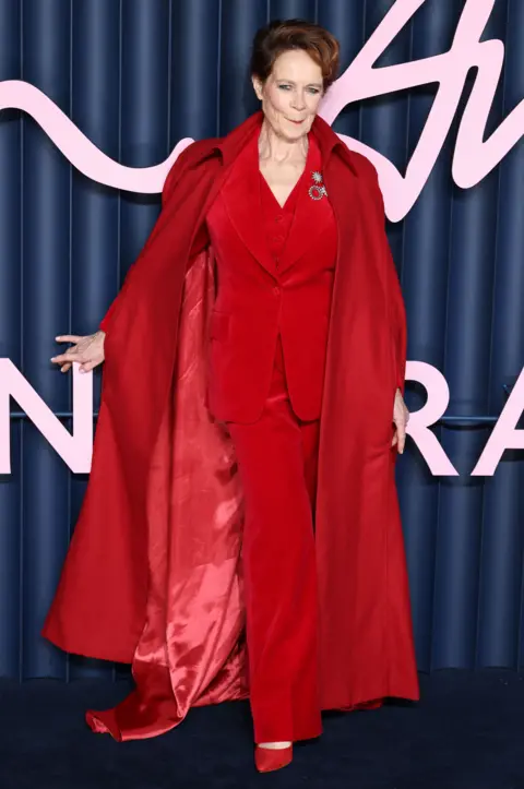 Getty Images Celia Imrie in a red velvet suit and cape
