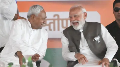 Hindustan Times via Getty Images Prime Minister Narendra Modi, right, and Bihar Chief Minister Nitish Kumar during a public meeting ahead of the state Assembly elections in Samastipur, Bihar