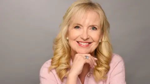 BBC Outgoing BBC Weather presenter Carol Kirkwood smiles in a portrait taken to mark her departure from the BBC. She is wearing a light pink top.