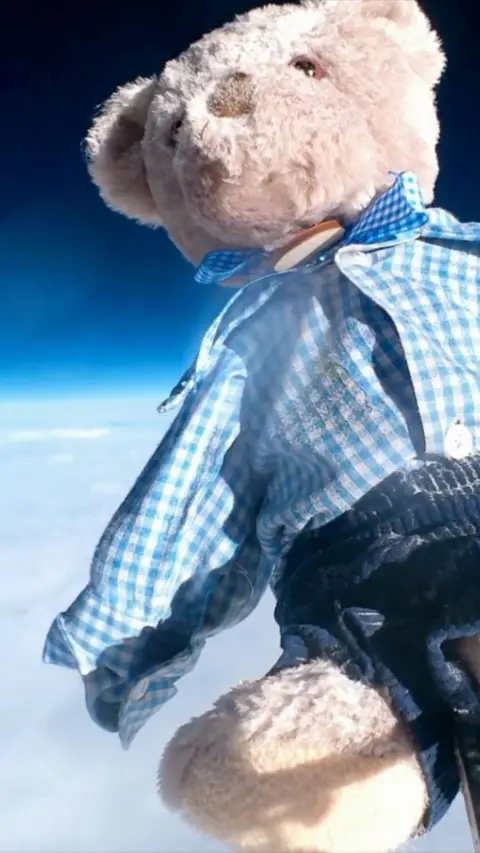 A teddy bear in space