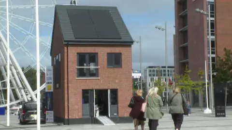 BBC The eco-friendly home built off site but assembled next to ACC Liverpool until the end of September 2024