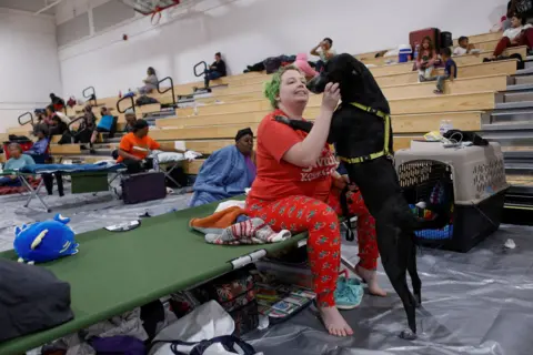 Octavio Jones/Reuters Amber Hardin, 27, spends time with her dog Ducky while taking shelter from Hurricane Helene at Leon High School near downtown Tallahassee, Florida 