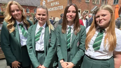 Gavin Kermack / BBC Four young teenage girls standing next to each other. They are all wearing the same school uniform - green skirts and blazers over white blouses and striped green ties.