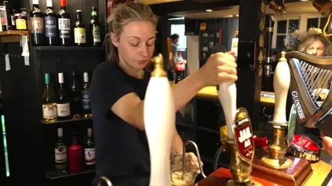 Hannah Canu pulling a pint at the Ship Inn