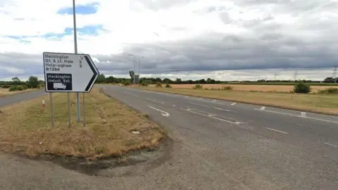 Google A long straight section of the A17, with a sign on the central reservation pointing towards Heckington