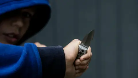 Getty Images A boy holding a knife