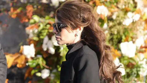 PA Media Cheryl wearing black glasses and a black coat