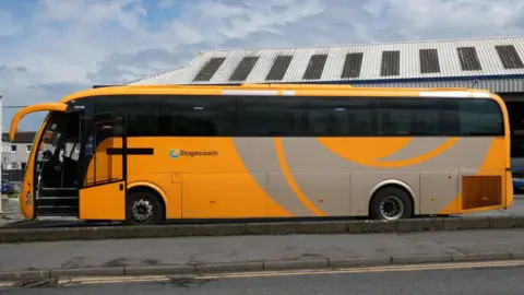 A yellow Stagecoach bus outside its Stranraer depot