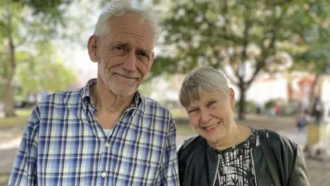 BBC News Steven Pidwill stands adjacent to his woman Rachel Hawley, 72, who has Alzheimer's. 