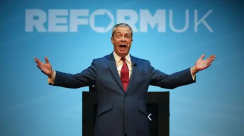 Getty Images Reform UK leader Nigel Farage speaks on stage during the Reform UK East Midlands Conference at the Athena Events Venue