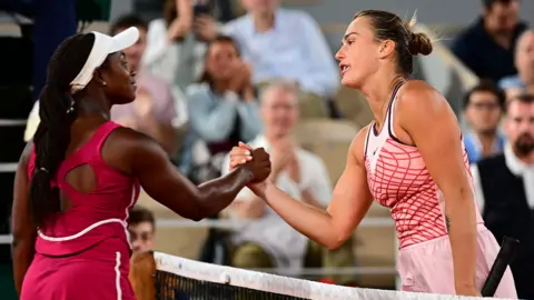 Sloane Stephens and Aryna Sabalenka shake hands after their night match in 2023