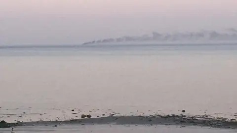 Pierre-Antoine McErlane  Smoke on the horizon from an out-of-view vessel, seen from the County Down coast