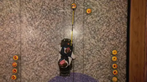 Preston Wheelchair Curling Club Overhead shot of a wheelchair curler sending his cue down the ice with a special cue.
