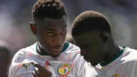 Senegal's Moussa Niakhate talks with team-mate El Hadji Malick Diouf during the group game with France at the 2026 World Cup