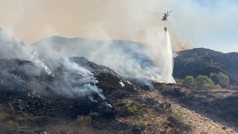 Helicopter waterbombing wildfire