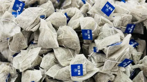 Blue Tea A pile of tea bags with a Blue Tea label