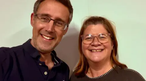 A head and shoulder shot of Ross Kay and Emma Cogan with a plain background.