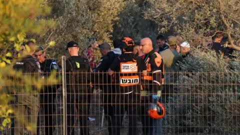 AFP: Israeli first responders and security forces in an olive grove near Haifa in northern Israel, where two people were killed in a Hezbollah rocket attack, October 31, 2024.