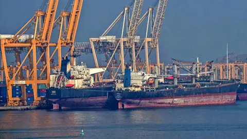 Tankers are seen at the Khor Fakkan Container Terminal, the only natural deep-sea port in the region and one of the major container ports in the Sharjah Emirate, along the Strait of Hormuz, a waterway through which one-fifth of global oil output passes on June 23, 2025. 