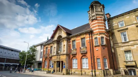Hull Central Library. The sky is blue with some white clouds. 