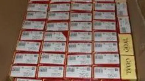 HMRC Neat rows of boxes of cigarettes within a brown cardboard box
