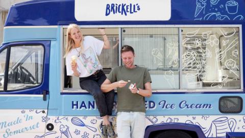 Two people alongside an ice cream van