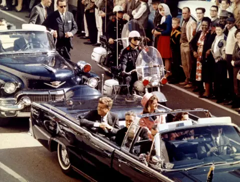 Reuters A general view of the car carrying JFK and Jackie Kennedy, filing past a crowd of onlookers