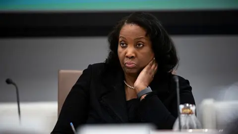 Lisa Cook sitting at a table, wearing black, at a Federal Reserve meeting in June 2025. 