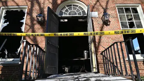 Getty Images An entrance to the Pennsylvania governor's mansion is shown with police tape across it and broken windows.