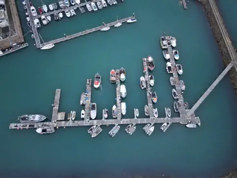 This is an aerial view of Fishermans quay area with fishing boats, in St Helier.