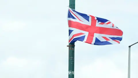 A union flag flying from a lamp post