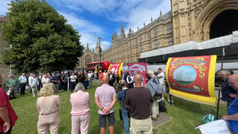 Campaigners with mining banners outside the Houses of Parliament.
