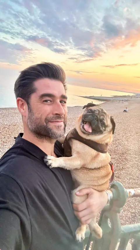 Matt Johnson Matt Johnson and pug Alan Shearer on the beach at sunset 