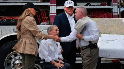 Trump and Melania meet with Texas officials and shake hands.