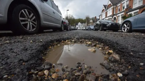 BBC A pothole in a road