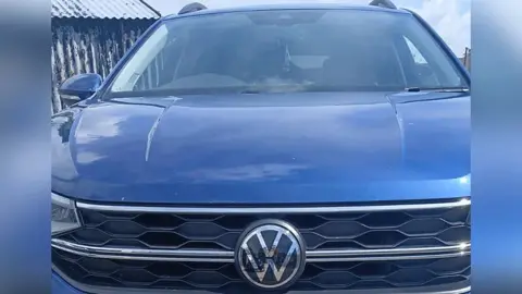 Cara Jones Close up of a blue volkswagen car.