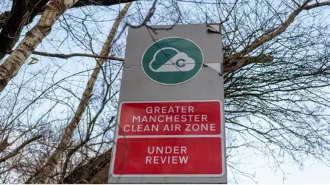 A sign advising motorists is seen at the entrance to the proposed clean air zone in Manchester.