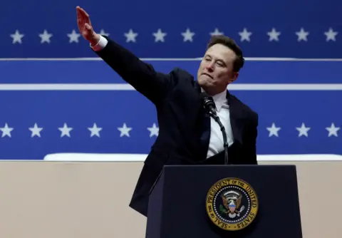 Musk gives a one-armed salute inside the Capital One arena in Washington on the inauguration day of Donald Trump