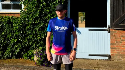 Jake Waine A man wearing running gear and a top which reads: 'The stroke association'.