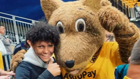 Family handout Harleigh Hepworth hugging a Wolves mascot