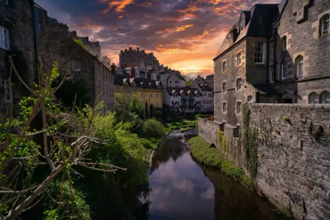 Garry Lynch Dean Village in Edinburgh as the sun sets over it