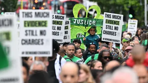 Getty Images People clasp  signs saying 'justice' arsenic  they be  the work  of remembrance to people    the seventh day  of the Grenfell Fire successful  London connected  14 June