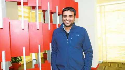 Mint via Getty Images Deepinder Goyal, CEO, Zomato in a blue jacket, smiling at the camera. 