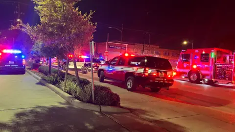 Houston Fire Department / X Emergency vehicles driving towards the scene of the crash on a Houston road.