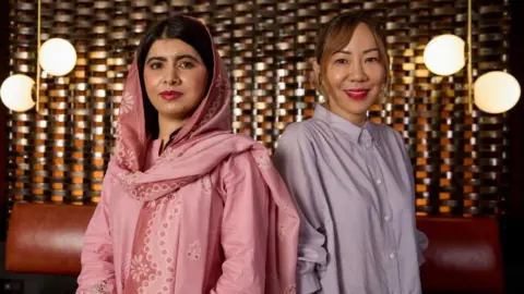 Apple Malala Yousafzai and Sue Kim posed together at the Toronto International Film Festival in September